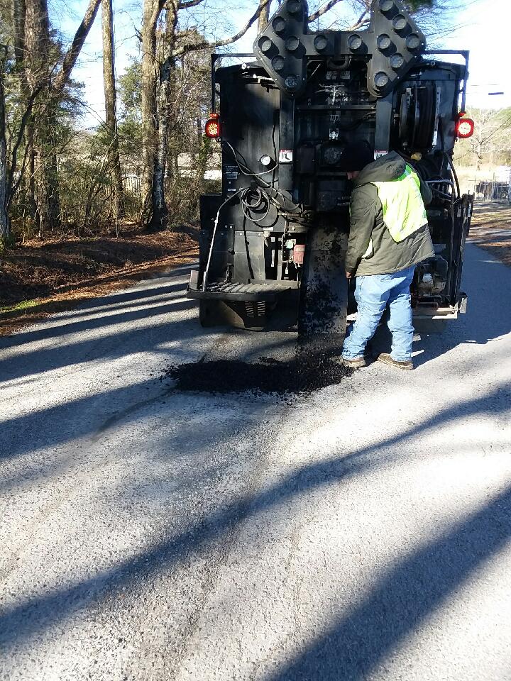 Street crew patching a pothole.